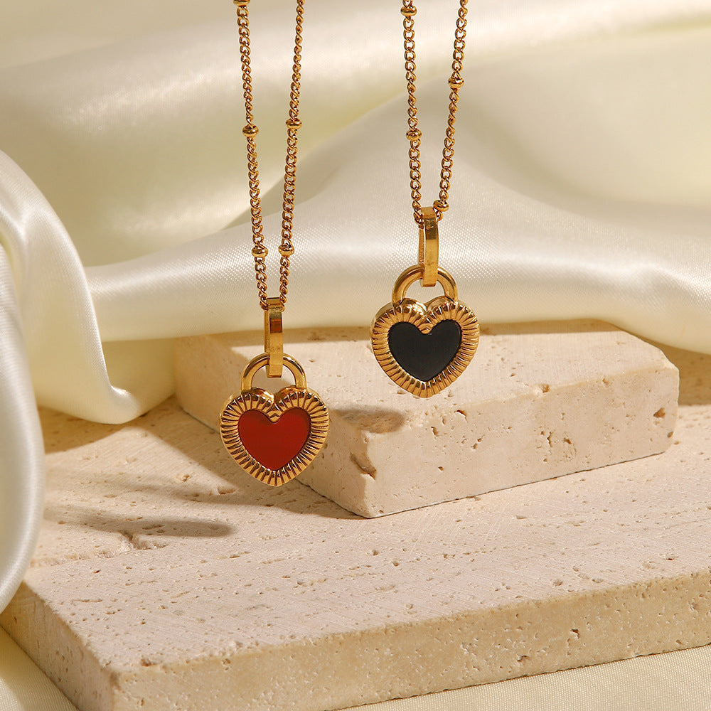 2 necklaces hanging in front of fabric