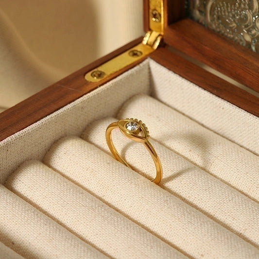 Gold evil eye ring placed inside a velvet jewellery box