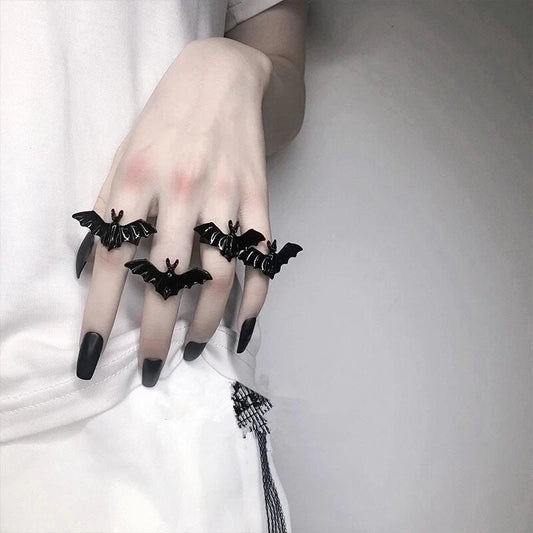 4 Bat rings on fingers.