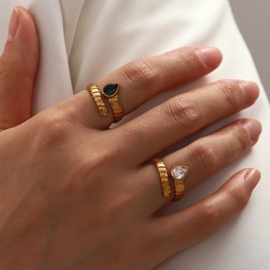 The different coloured stone rings, being worn on the index and pointer finger.