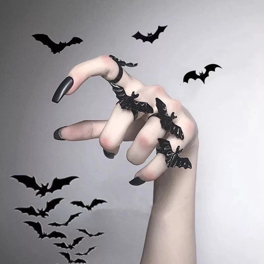 4 Bat rings on fingers, with Bats flying in the background.